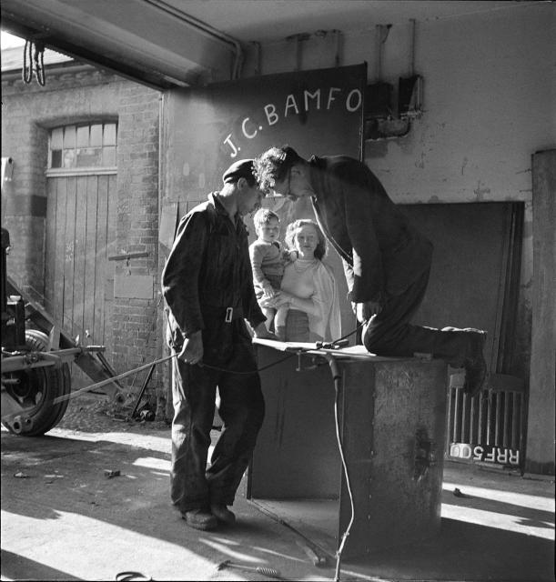 1948__JCB_moves_to_stables_at_Crakemarsh_Hall._Anthony_Bamford_in_the_arms_of_his_mother_Marjorie_as_Bill_Hirst__left__and_Arthur_Harrison_are_at_work_02.jpg