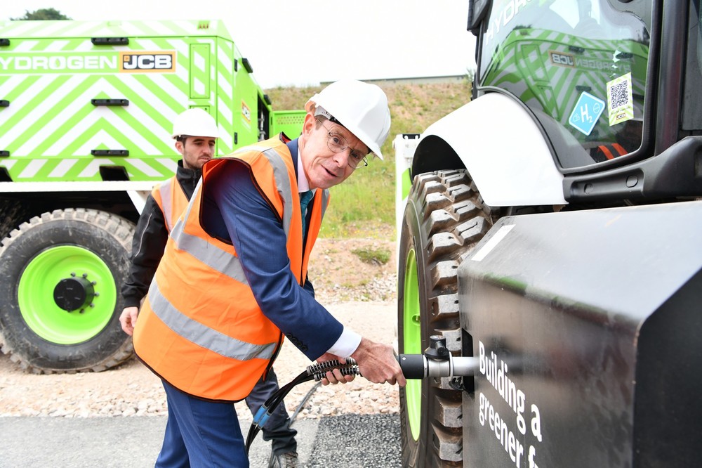 West Midlands Mayor Andy Street refuels a JCB backhoe loader with hydrogen from the new JCB refueller during a visit to JCB.jpg