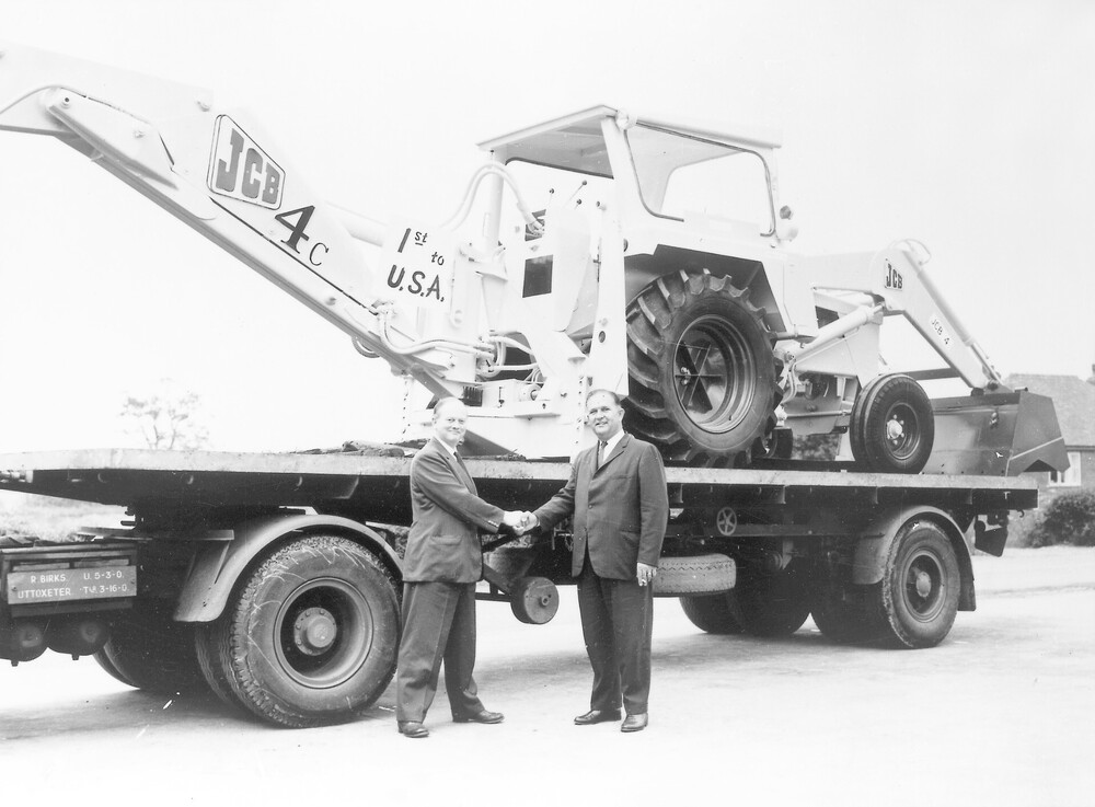 1964 - JCB exports its first machine, a 4C backhoe, to the USA. Mr Bamford is pictured left.jpg